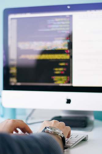work person in front of iMac tech