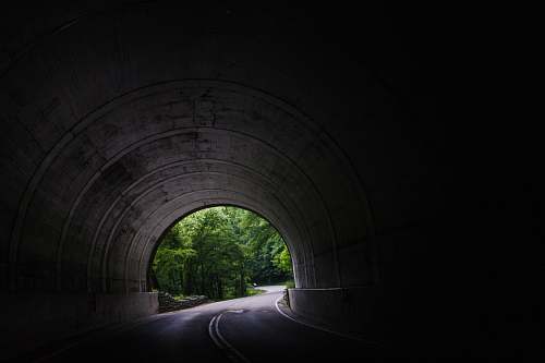passage tunnel near trees at daytime passageway