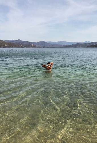 swimming landscape photo of a man on the beach human