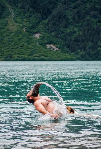 human man bathing on body of water person