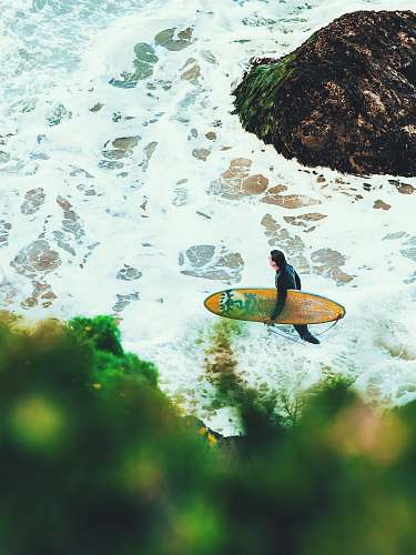 surfboard man on beach carrying surfboard sea