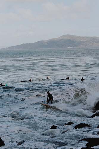 human people in ocean during daytime person
