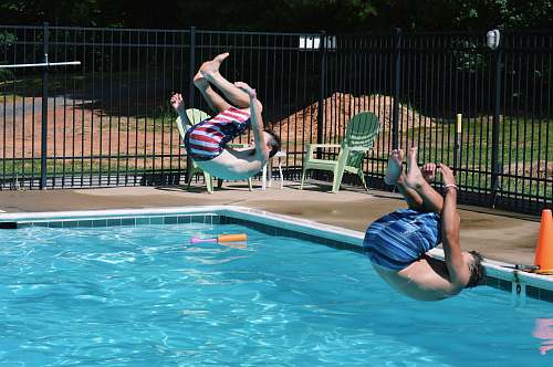 diving two men jumping on swimming pool diver