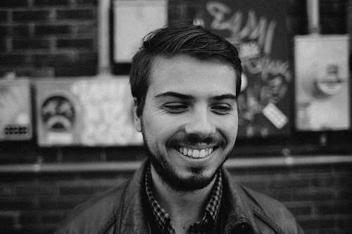 person grayscale of man smiling human