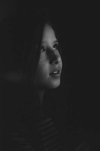 portrait grayscale photography of a girl looking up person