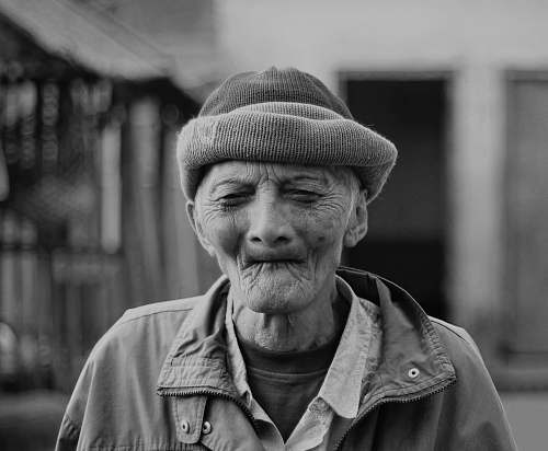 person grayscale photography of man closing his eyes while taking him a picture human