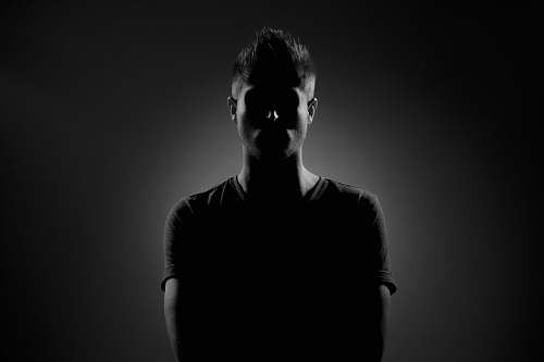 person grayscale photography of man wearing black t-shirt human