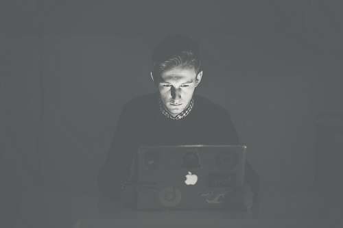 grey man staring at black MacBook face