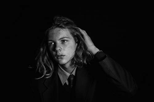 people man wearing black blazer on black background portrait