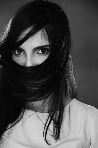person woman covering her lips with hair human