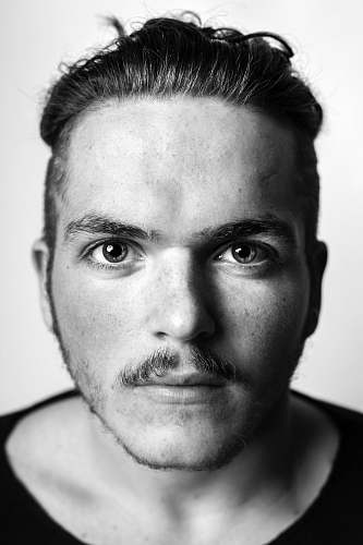 portrait grayscale photography of man in scoop-neck top black-and-white