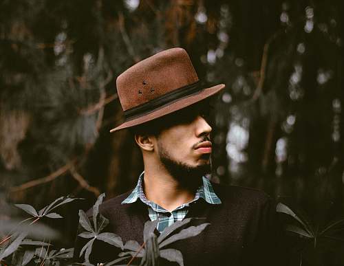 man man wearing brown hat standing front of tree male