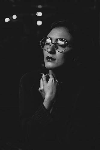 person grayscale photo of woman wearing eyeglasses black-and-white