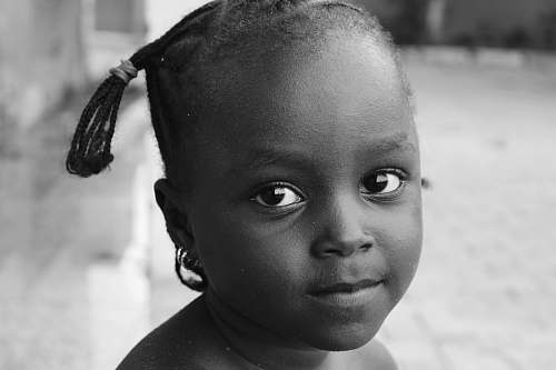 person grayscale photography of child black-and-white