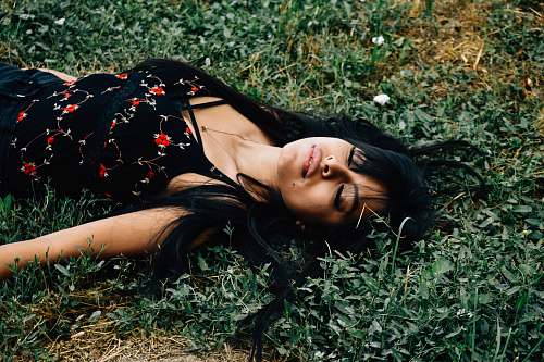 person woman lying on ground at daytime people