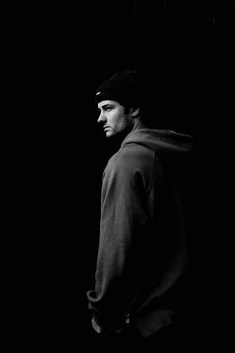 human grayscale photo of man wearing hoodie and knit cap black-and-white