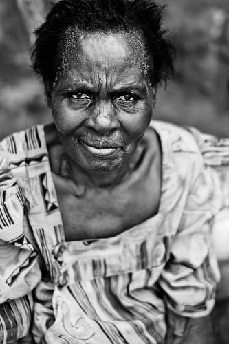 person grayscale photo of woman wearing dress black-and-white