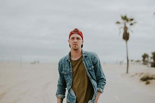human man standing on road between sand person