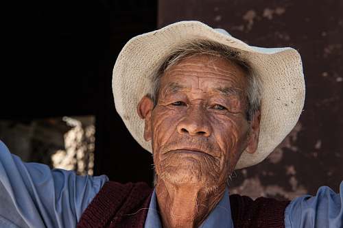 person man wearing white hat selective focus photography old man