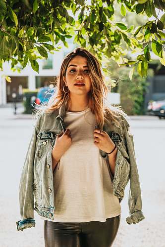 person portrait photography of woman wearing white shirt and gray denim jacket human