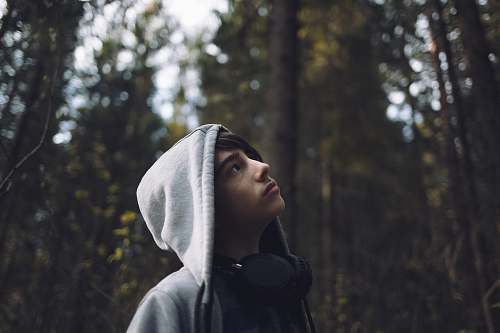 person shallow focus photo of man looking at trees human