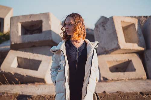 woman woman in white full-zip bubble jacket standing and looking right side person