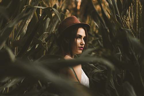 woman woman in white shirt with hat standing on corn field female
