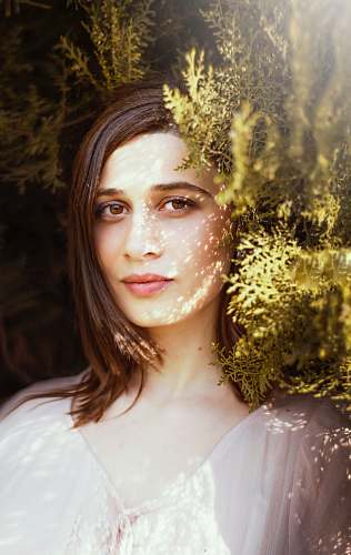 portrait woman near green leafed plants during daytime woman