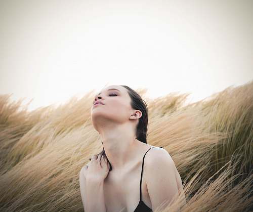 woman woman sitting along brown plants person