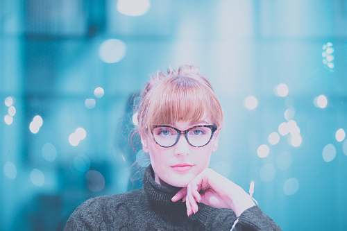 person woman wearing gray turtle-neck sweater posing at camera glasses