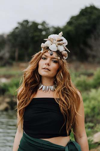 woman woman wearing seashell crown in shallow focus photography person