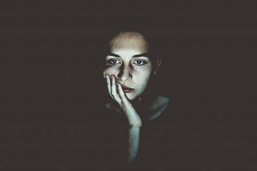 human woman with head resting on hand face