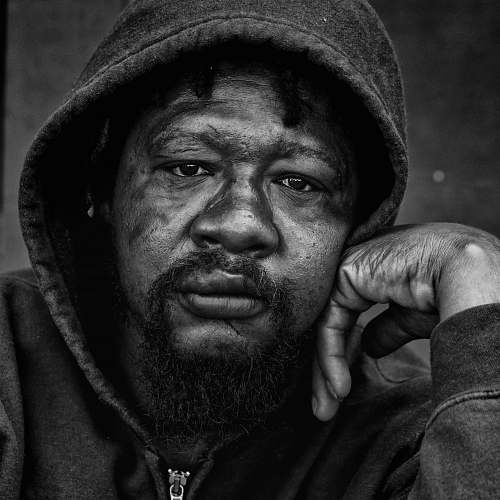 human grayscale photo of a man wearing hoodie black-and-white