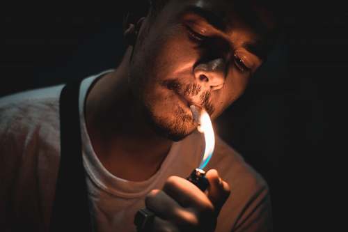human man lighting cigarette people