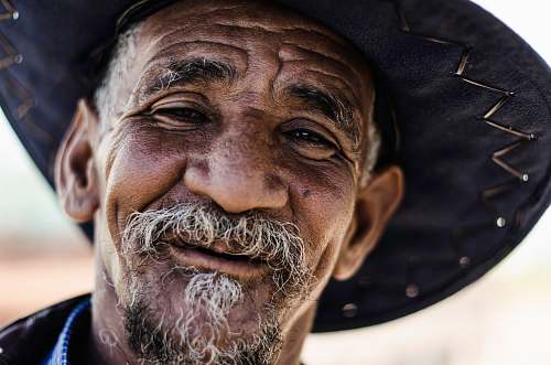 face closeup photography of man wearing black hat old man