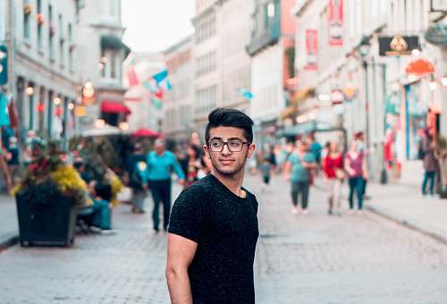 human man wearing black crew-neck T-shirt during daytime man