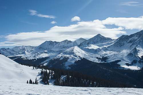 nature snow covered mountain under blue cloudy skies mountain