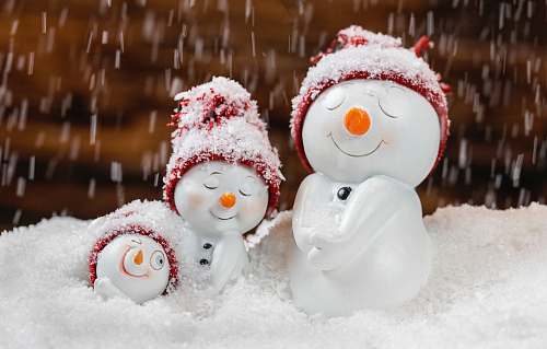nature snowman with red and white hat outdoors