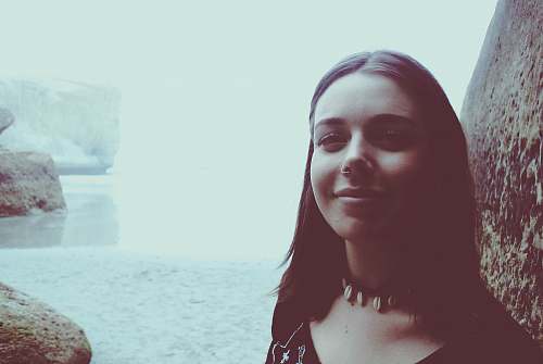female woman taking selfie near body of water and rocks new zealand