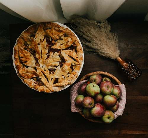  brown and green round fruit on brown wooden table 
