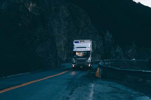 road trailer truck passing on road near rail guard transportation