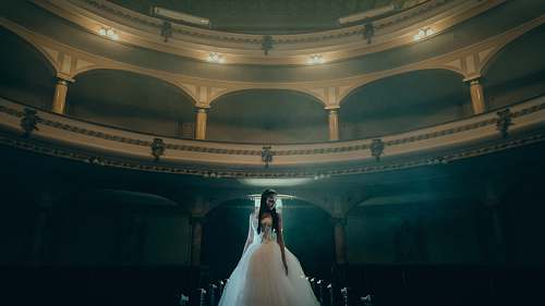 clothing woman in white dress standing inside dome building apparel