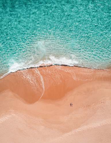 mexico aerial photography of two person sunbathing on seashore blue