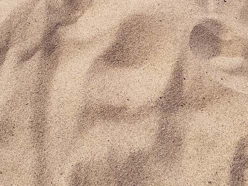 sand focus photo of brown sand soil