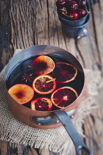 winter close-up photography of sliced orange fruit on brown cooking pot london