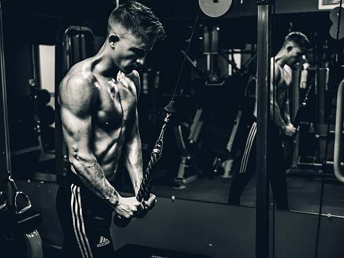 gym grayscale photo of man exercising grey
