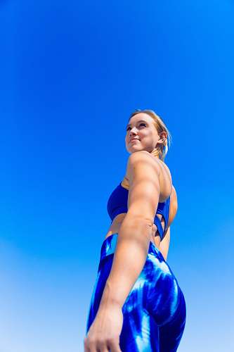 person low angle photography of woman in blue brassiere and blue bottoms clothing