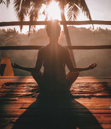 people woman doing yoga meditation on brown parquet flooring yoga