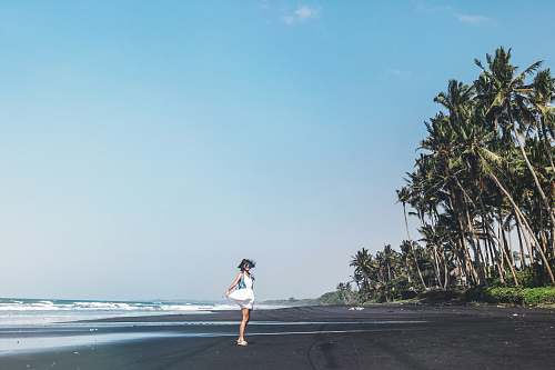 exercise woman standing on beach during daytime jogging