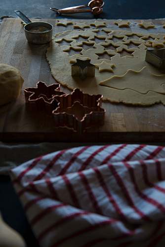biscuit assorted-shape gray molds beside dough on chopping board cookie